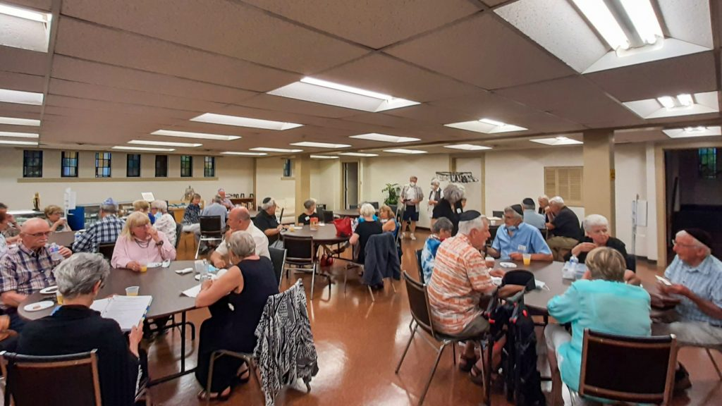 The Tomarin Room filled with people and round tables.